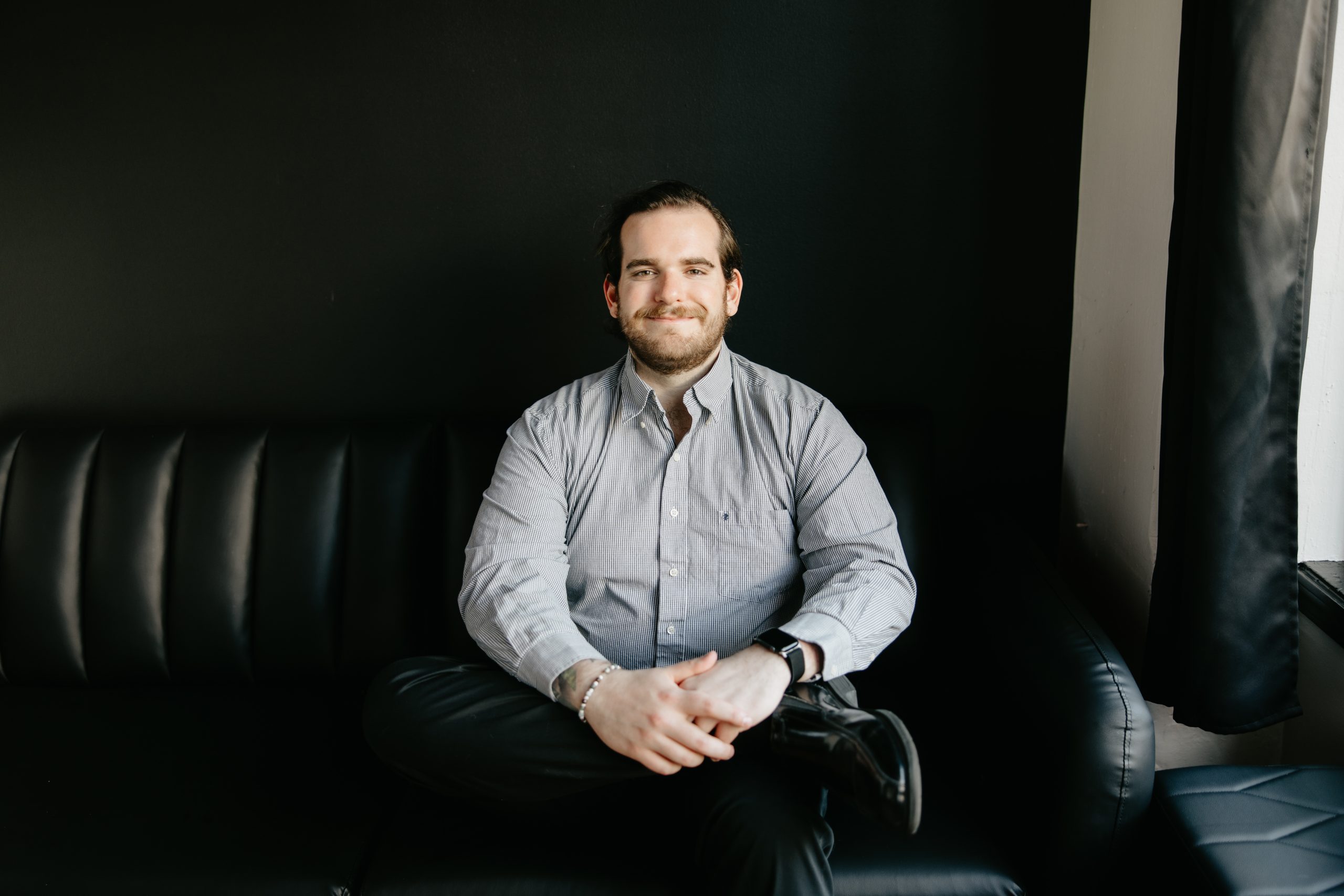 Austin Boardman Sitting on a couch ready to have a conversation