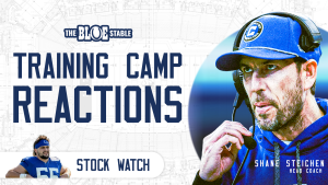 Youtube thumbnail for Training Camp Reactions. There is a photo of Shane Steichen on the right with a stock watch label on the left with Caden Curry